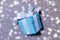 Festive small box with a gift, tied with a ribbon with a bow. Background with snowflakes. The concept of holiday gifts for Christm