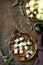 Festive snack of fruit and berry canapes. Halloween party food. Canapes with melon and blackberries on a wooden table. Top view.