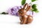 Festive still life with Chocolate Easter Bunny and lilac flowers.