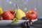 Festive still-life from fresh multicolored fruits on a beautiful background.