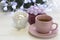 A festive still life with tea, a giftbox and Christmas-tree ball in a tea mug