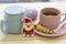 A festive still life with tea, a sugar bowl and Cristmas-tree toys