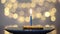 Festive sweet birthday cake with burning candles against bright bokeh background. Greeting card. Party and holiday celebration
