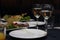 A festive table with appetizers, appetizing salads, sausages and champagne in glasses in a restaurant in the evening.