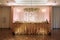 Festive table for the bride and groom decorated with gold cloth, white and pink flowers and candles. wedding day