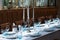 Festive table set with white cloth, plates, forks, blue glasses and candlestick with white candles for wedding, family event