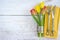 Festive table setting with original cutlery on yellow napkin