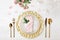 Festive table setting with plates, cutlery and napkin on wooden background