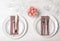 Festive table setting with plates, cutlery and napkins on wooden background