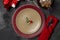 Festive table setting for Valentine`s Day with fork, knife and heart pin with rosemary at plates on a black table. Top view