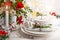 Festive table setting with winter flower arrangement on table decorated for holiday. Christmas or New Year dinner concept..