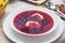 Festive table with traditional red borscht with dumplings