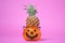 Festive treat for halloween pineapple in candlestick. Sweetness or nasty