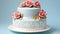 Festive white cake decorated with flowers on a blue background