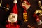 Festive winter toys and soft Santa Claus for new year tree on wooden background as winter holidays decoration.