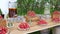 Festive wood table with strawberries, pitcher since cool tea and lemon, non-alcoholic mojito, on background nature