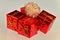 Festive wrapping on gifts topped with a cream pompom