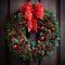 A festive wreath made up of pine cones and holly berries,