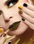 Festive yellow black manicure and makeup .