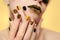Festive yellow black manicure and makeup.