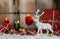 Festively christmas decoration with red gifts and a white reindeer in the snow.