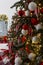 Festively decorated Christmas tree with gifts in the New Year`s interior. Close-up. Vertical