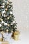 Festively decorated Christmas tree with gifts in the New Year`s interior. Close-up. Vertical. Soft focus
