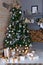 Festively decorated living room with Christmas tree and garland. Christmas room interior in scandinavian style. Christmas tree wit