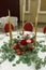 Festively decorated round banquet table in the restaurant. Fresh flowers are golden candles and garnet and red chairs. expensively