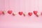 Festively decorated Valentines Day hearts on a pink background, flat lay. space for text