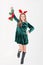 Festively dressed cute girl wearing reindeer antlers holding Christmas decorations on isolated white background