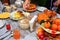 Festively laid table. Beautifully decorated dishes. Hand puts a spoon salad.