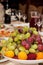 Festively laid table with fresh fruits in a vase in the foreground