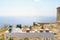 A festively served buffet table with water, champagne and fruits on plates against the backdrop of an old building by