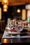 Festively table setting in a restaurant, close up two empty shiny wine glasses. Served table for wedding, birthday