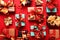 Festively wrapped gift boxes on red background. Flat lay style. Holiday concept