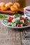 Feta arugula salad with tomatoes on white plate, summer food