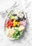 Feta, orzo, tomatoes, cucumbers, radishes, olives, peppers salad on a light background, top view. Healthy food diet concept. Medit