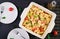 Fetapasta. Trending Feta bake pasta recipe made of cherry tomatoes, feta cheese, garlic and herbs. Table setting.