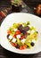 Feto cheese roca salad with tomatoes, cheese, bell pepper, olive cubes and basilic.