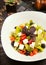 Feto cheese roca salad with tomatoes, cheese, bell pepper, olive cubes and basilic.