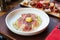 Fettuccine Carbonara with parma ham and yolk with black pepper. Served in white plate