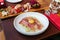 Fettuccine Carbonara with parma ham and yolk with black pepper. Served in white plate