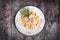 Fettuccine pasta with meat, cream sauce and herbs on a plate on wooden background