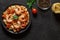 Fettuccine pasta, shrimp, tomatoes, spices, parsley - cooked Italian dish with ingredients, on dark background, top view, space to