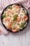 Fettuccini pasta in cream sauce with shrimp on a plate. vertical