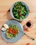 Fetuchini pasta with beef tomato sauce on wood table , italian food. Fresh salad in a gray plate with arugula