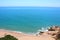 A few couples of swimmers enjoy wonderful weather in Calella de Costa\'s Rocapins beach.