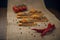 A few crackers with poultry pate, red cocktail tomatoes and hot pepper on the sackcloth and wooden background