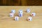 A few dice lies on the surface of natural wood. Items for generating numbers from one to six in the form of points that are paint